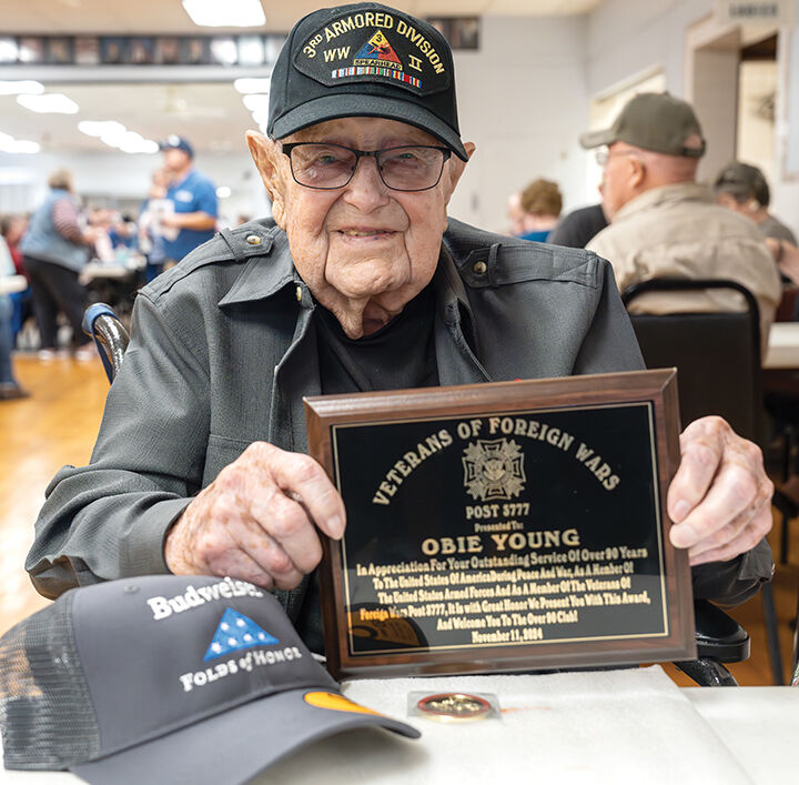 Obie Young, 106, receives his award.